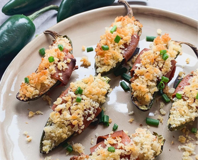Vegan jalapeno poppers with cream cheese and vegan salami wrapped in breadcrumbs.