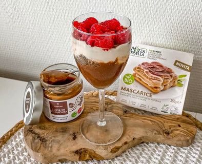 Vegan chocolate raspberry parfait with layers of chocolate spread, mascarpone, chia seeds, and fresh raspberries.
